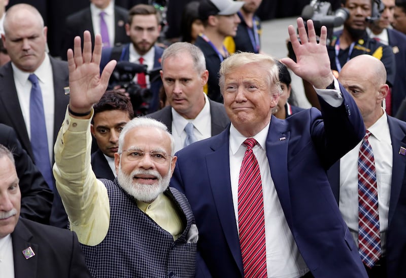 India Prime Minister Narendra Modi and then-President Donald Trump greet attendants after Modi's speech during the "Howdi Modi" event, Sept. 22, 2019, at NRG Stadium in Houston.