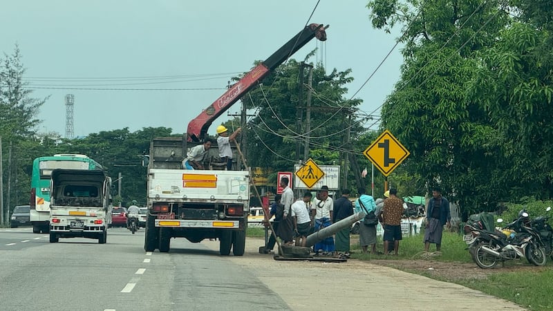 ရန်ကုန်တိုင်း၊ မင်္ဂလာဒုံမြို့နယ်တွင် ဓာတ်မီးတိုင်ပြင်ဆင်နေသည့် လျှပ်စစ်ဝန်ထမ်းများအား ၂၀၂၄ ခုနှစ်၊ နိုဝင်ဘာလ ၃ ရက်နေ့က တွေ့ရစဉ်။ (RFA Photo)