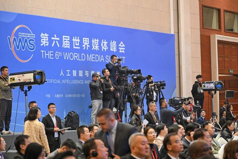 Journalists work at the opening ceremony of the 6th World Media Summit in Urumqi, capital of northwestern China's Xinjiang region, Oct. 14, 2024. (Chen Yehua/Xinhua via Getty Images)