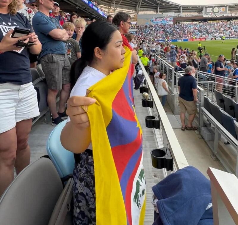 A member of the Regional Tibetan Youth Congress (RTYC) in Minnesota holds a Tibetan flag during a women’s soccer friendly between the United States and China in St. Paul, Minnesota, May 31, 2025.