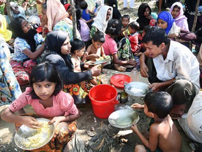 Rohingya Muslim refugees from Myanmar, who entered Bangladesh by boat, rest as they wait to go to refugee camps near Thankhali refugee camp in Ukhia subdistrict, Cox's Bazar, southeastern Bangladesh, Nov. 10, 2017.