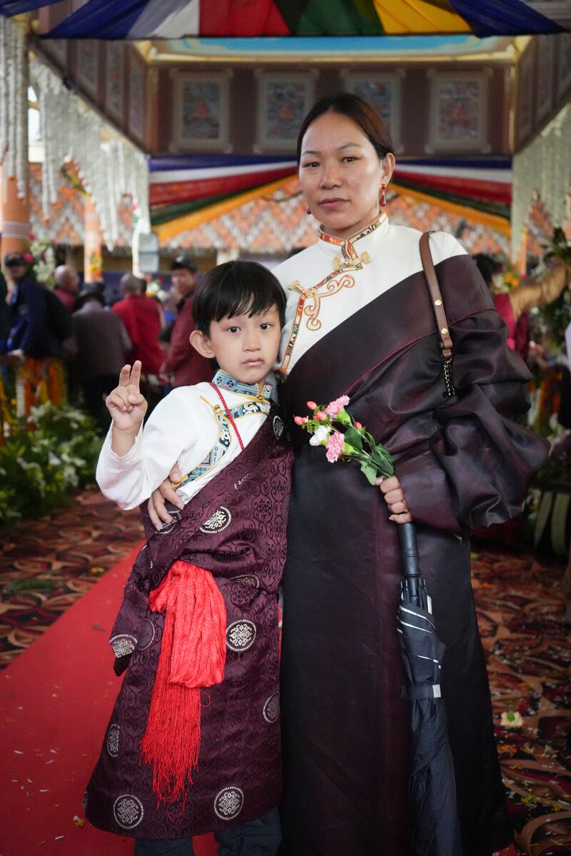 A woman and child in traditional Tibetan clothes during celebrations on the 90th birthday of the Dalai Lama at the Main Temple in Dharamsala, India, July 6, 2025.